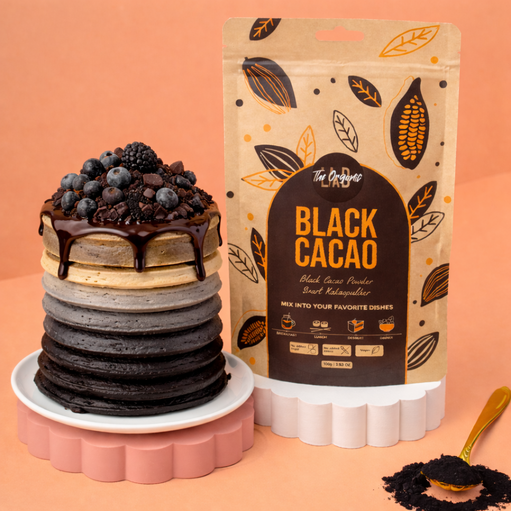 Ombre pancake stack from light to black using The Organic Lab Black Cacao Powder, topped with berries