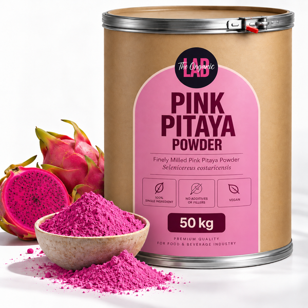 Bulk pink pitaya (dragon fruit) powder in a 50 kg drum with fresh dragon fruit