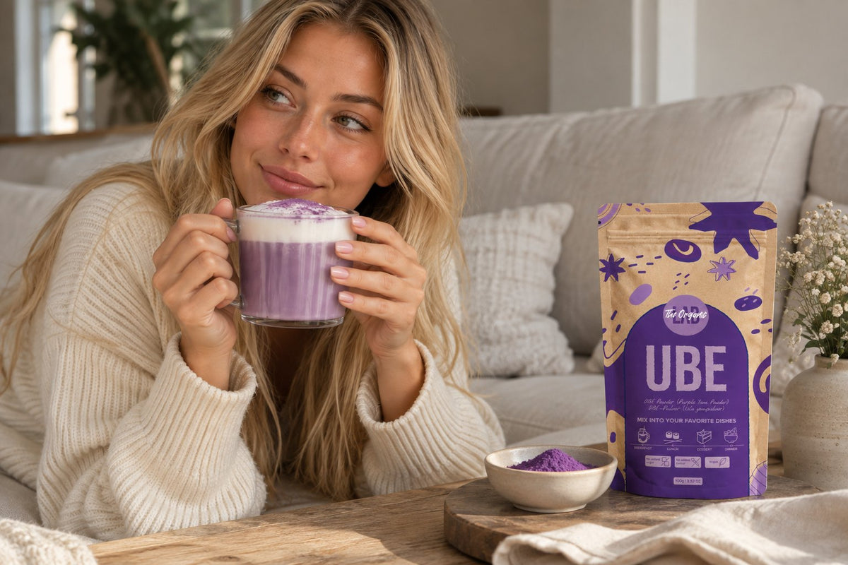 Woman enjoying an ube latte next to a pack of Ube Powder