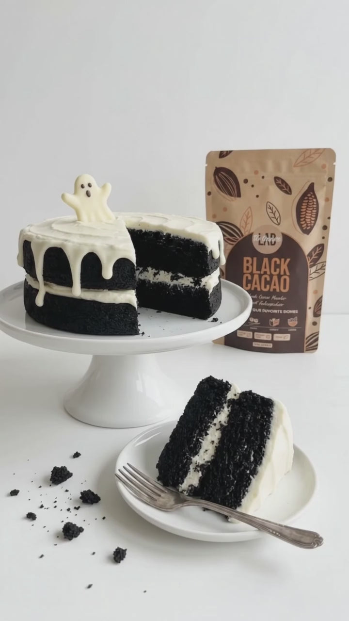 Black layer cake with white frosting made with Black Cocoa Powder